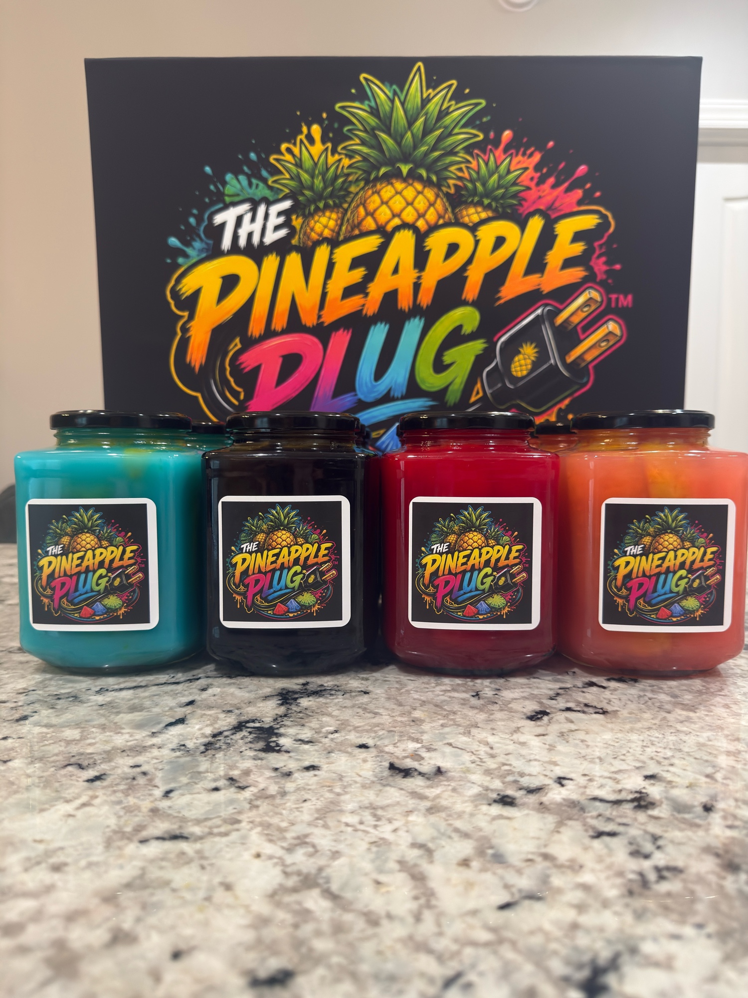 Four colorful jars of The Pineapple Plug flavored pineapples — blue, purple, red, and orange — lined up in front of the brand logo backdrop.